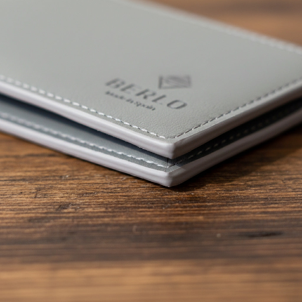 Macro close-up of edge painting, stitching, and matte texture.